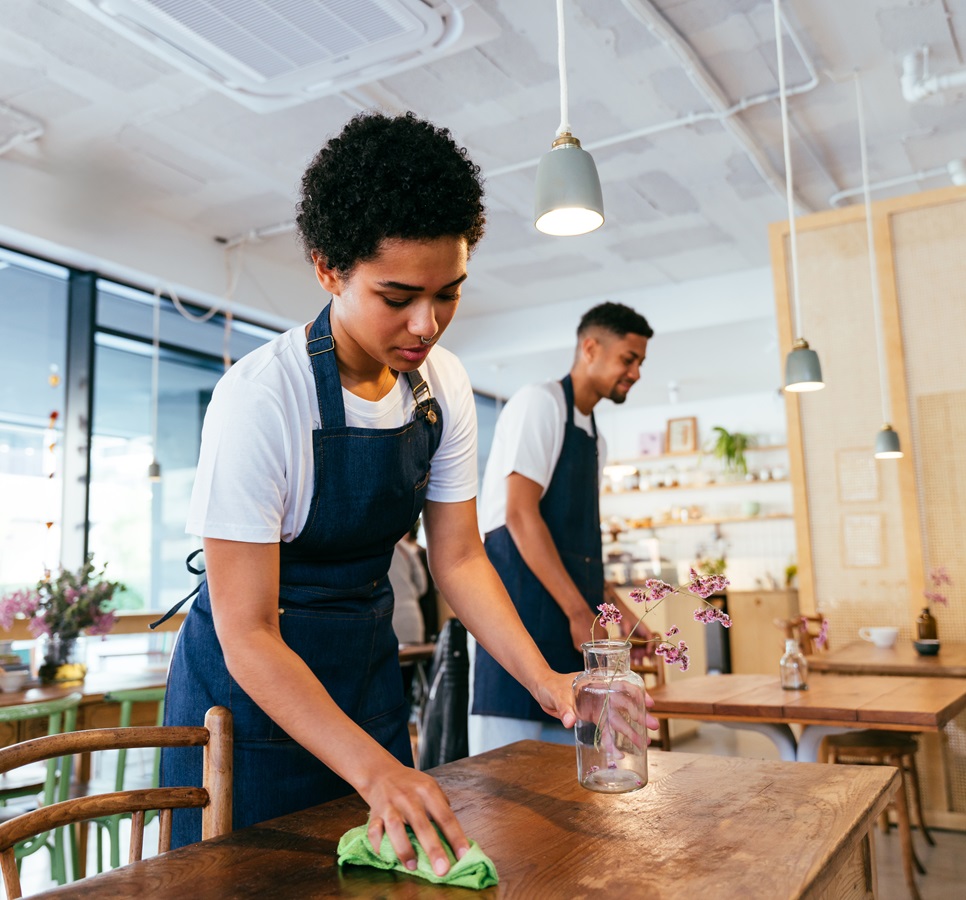 Barista and waiter working in a bar cafeteria shop